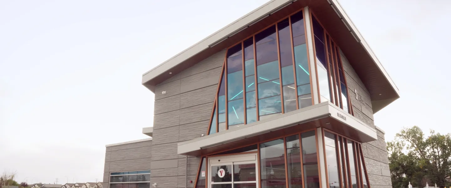 A large building with pointed roof on a gloomy day.