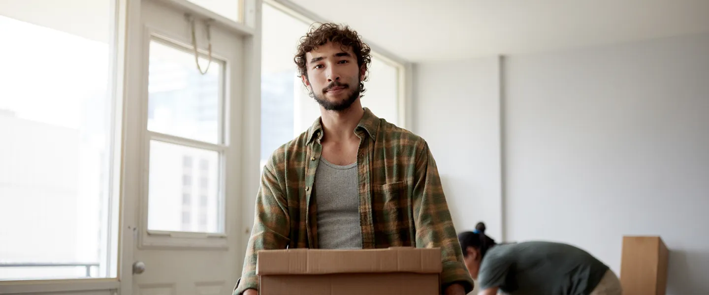 man carrying a box - nc housing web banner