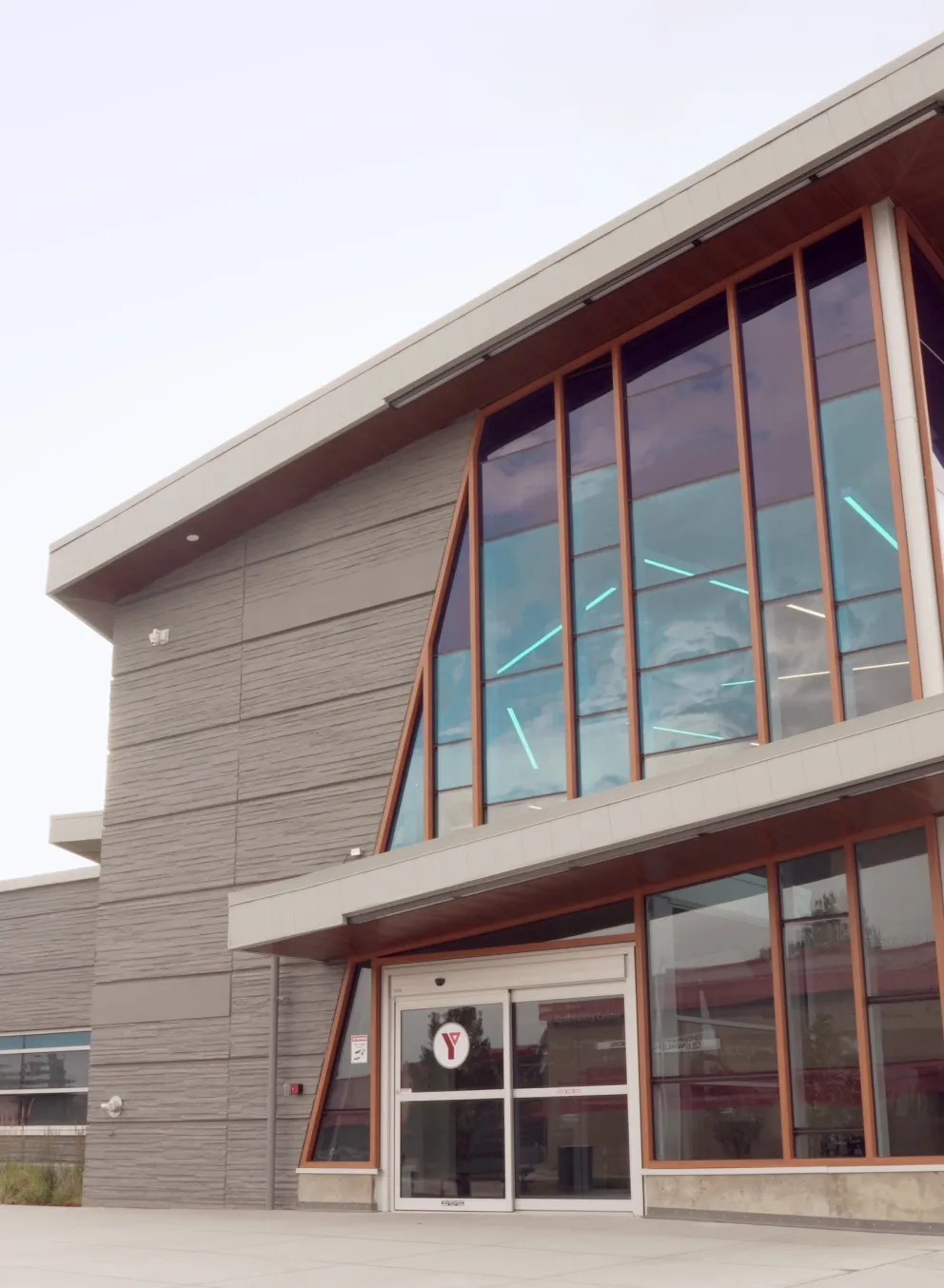 A large building with pointed roof on a gloomy day.
