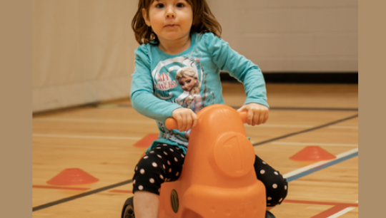 Little Girl riding her bike in Mount Pleasant YMCA Child Care - Southwest - Edmonton